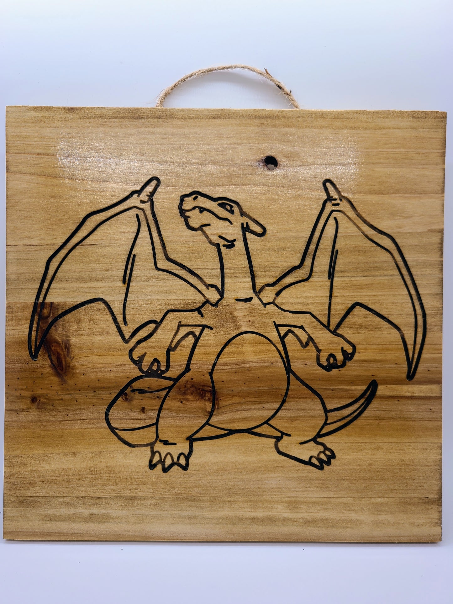Fiery Charm: Charizard Laser Engraved Artwork.