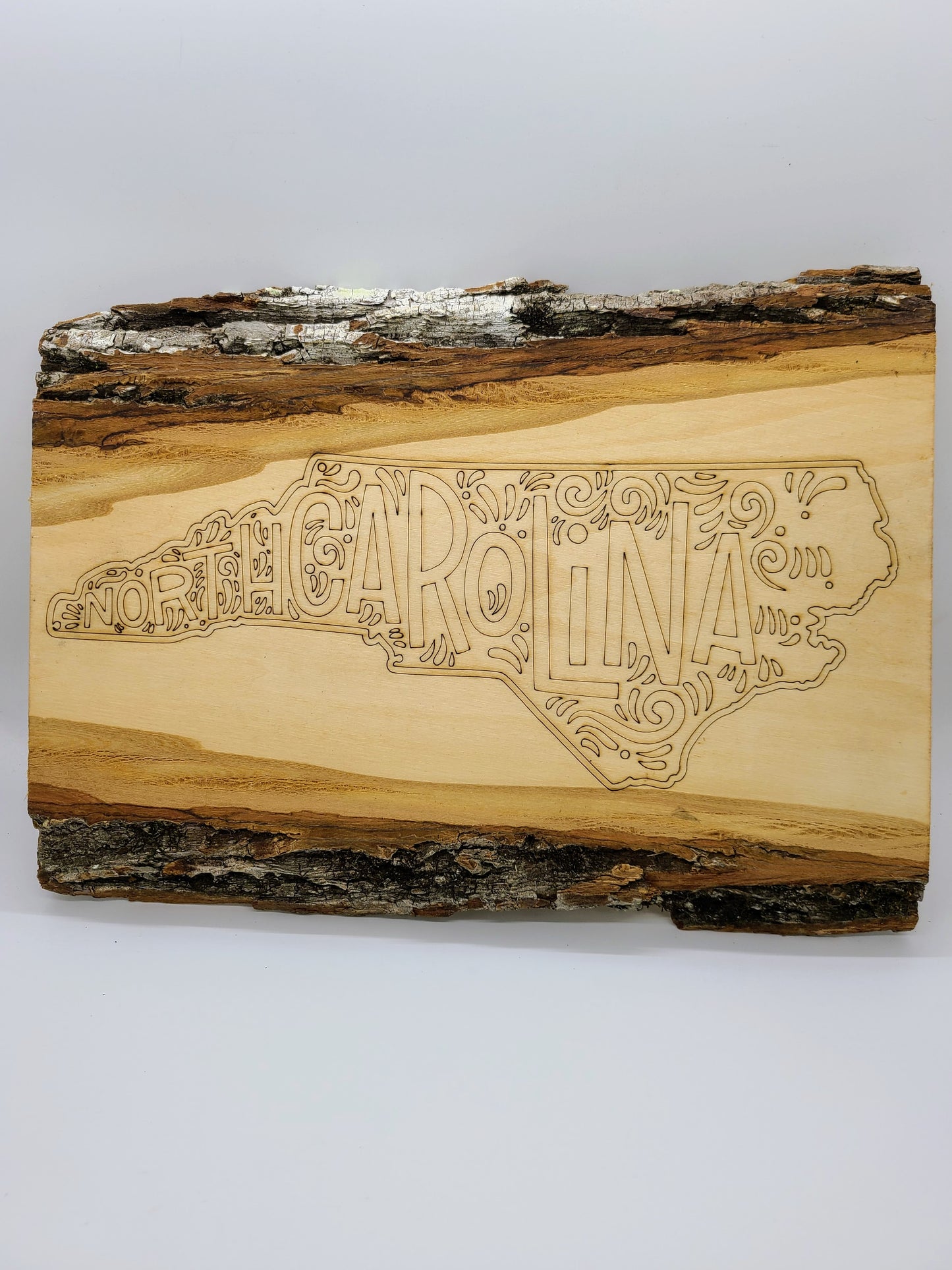 Laser engraved state on wood.